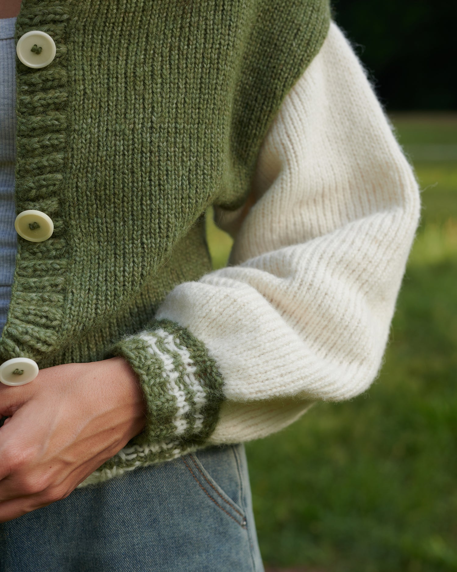 Alpaka College Cardigan VIVIAN Detailansicht an Model stehend in der Farbe natur oregano