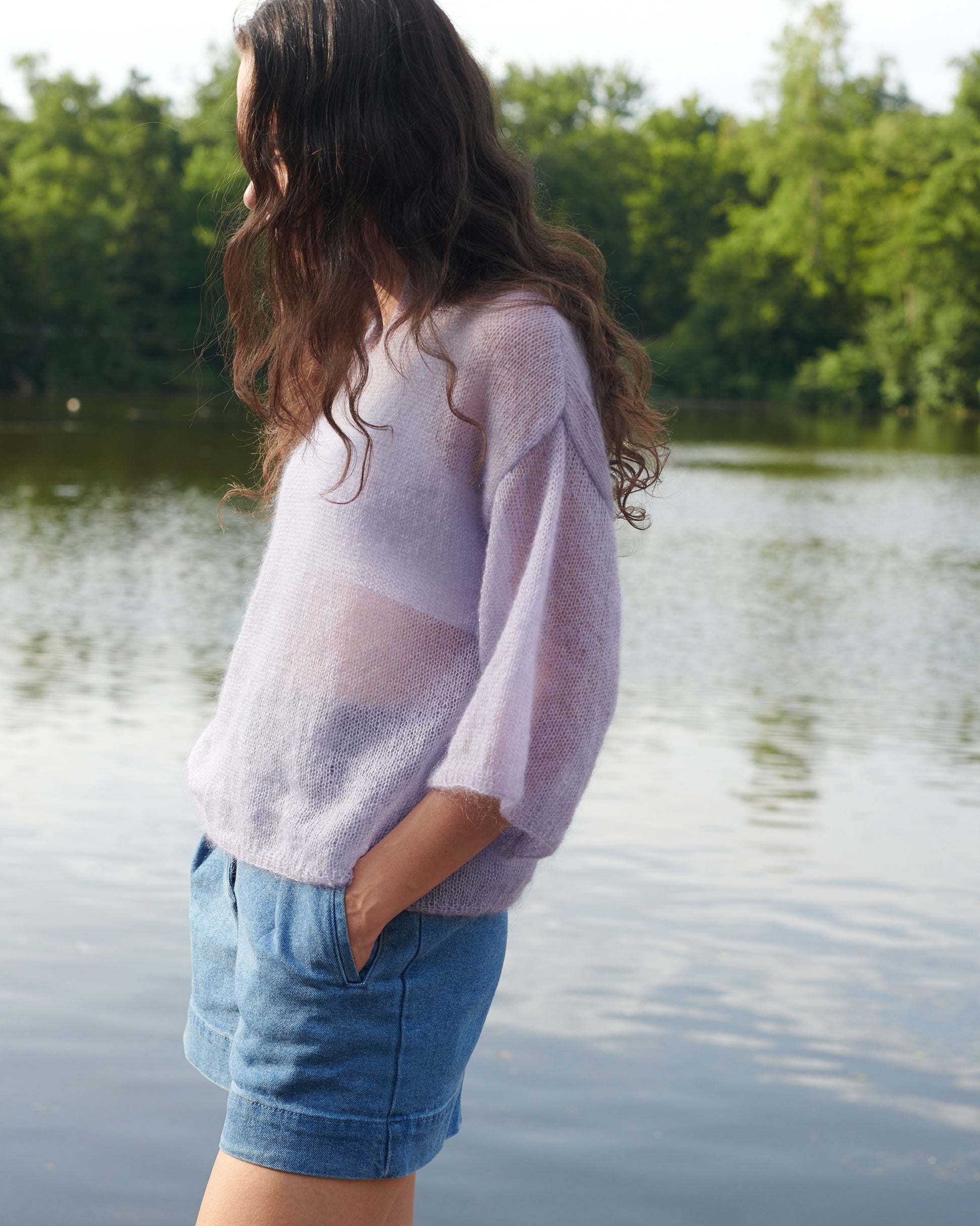 Mohair Seide Pullover FRIDA mit Rueschenkragen und Schlitz Seitenansicht an Model an See in der Farbe lila nebel.